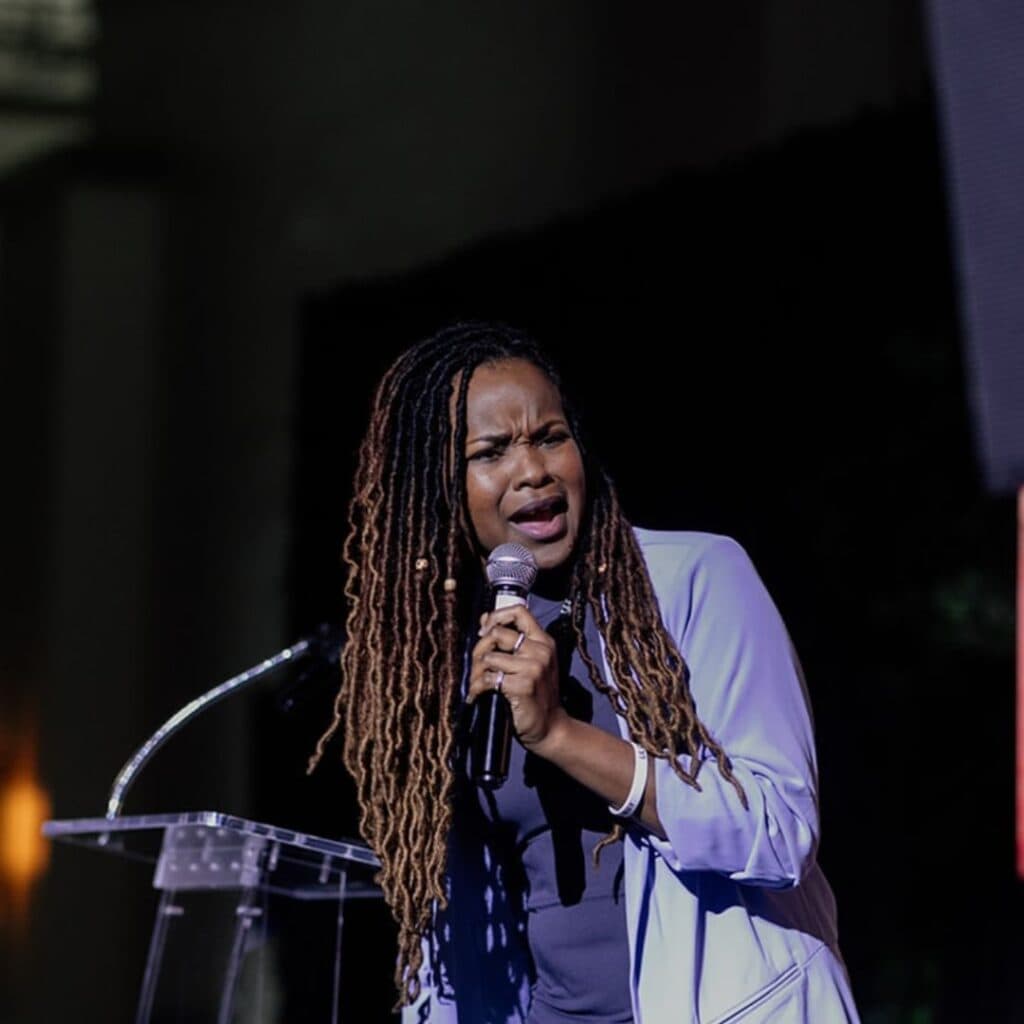 Shy Speaks on stage purple suite (hip hop)