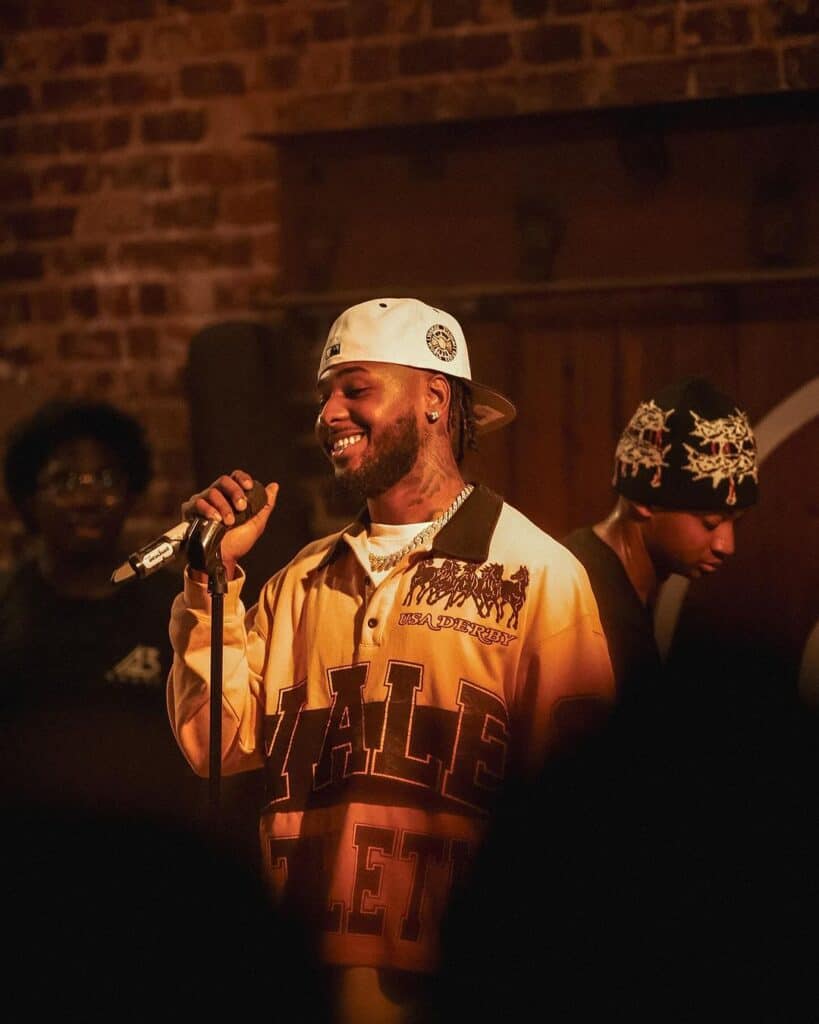 Alex Jean smiling onstage